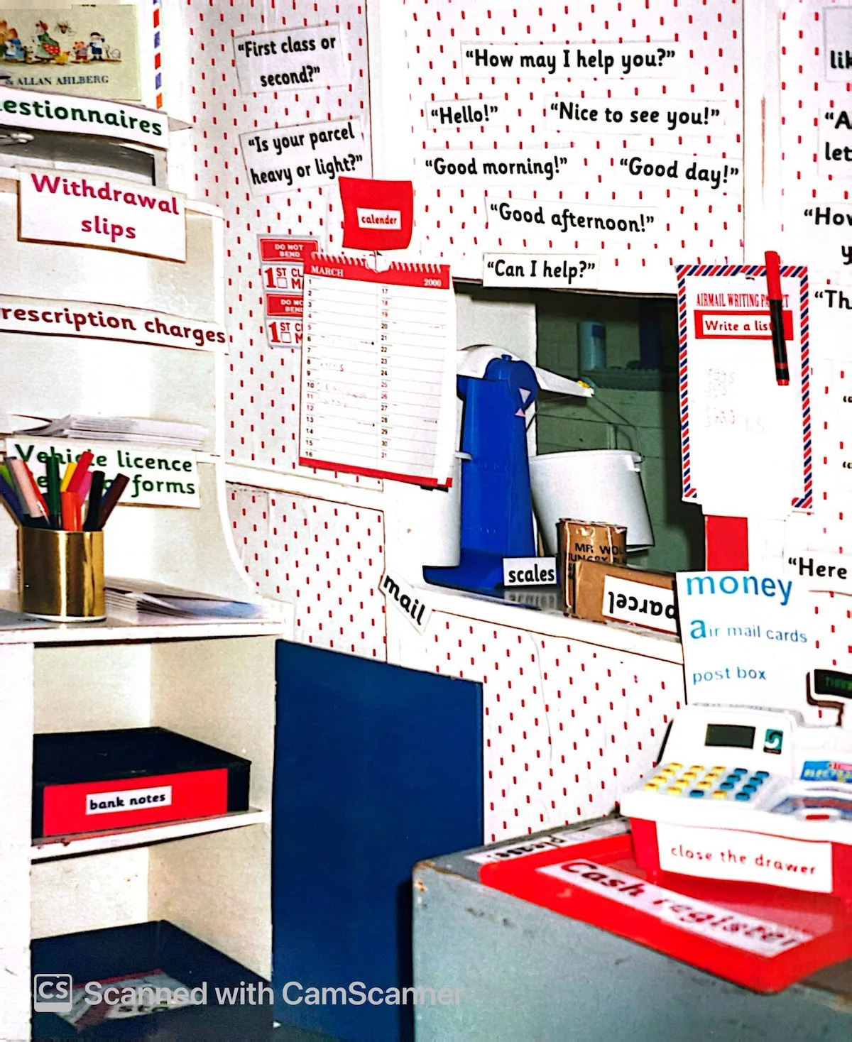 A classroom post office service hatch surrounded by conversational prompts to support customer service roleplay.